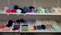 multicolored face masks on a white shelf
