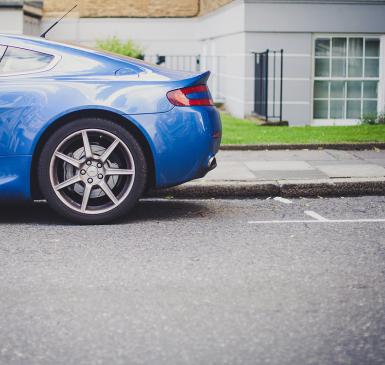 Image: blue car in parking spot. Topic: Reduce Your Carbon Footprint