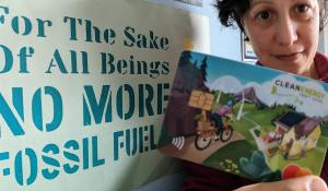 Image: Woman holding a card that reads "clean energy"