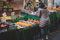 Image: street market with fruit and vegetables. Article: Buying Local and Going Green