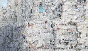 Image: huge bales of paper trash. Topic: Why Recycled Paper?