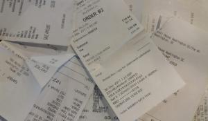 Image: pile of paper receipts. Topic: Skip the Slip Report: Environmental Costs & Human Health Risks of Paper Receipts