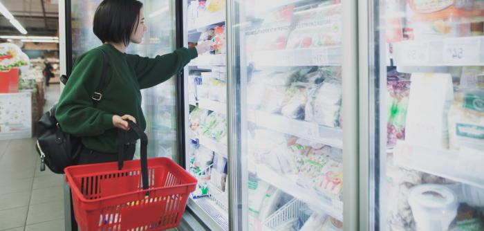 Image: shopper standing in front of supermarket coolers. Topic: Cool It for Climate