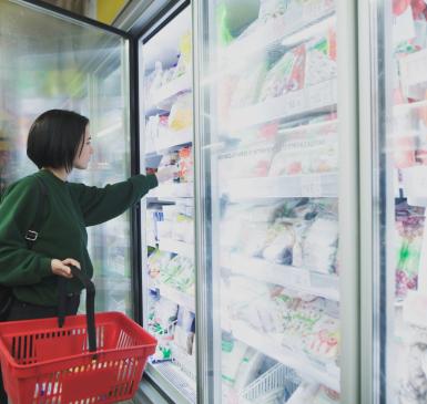 Image: shopper standing in front of supermarket coolers. Topic: Cool It for Climate