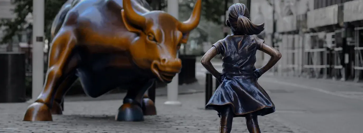 girl in front of bull statue wall street