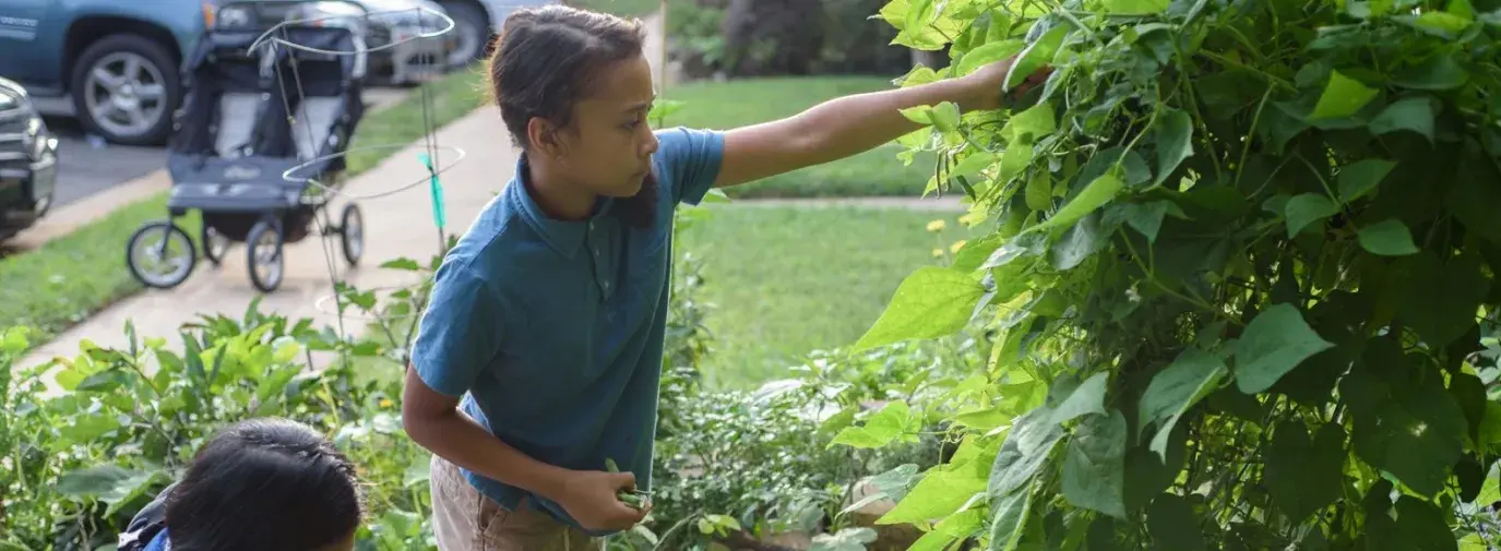 Nicky Schauder and her children working on the garden in their front yard in Herndon, Virginia. Photo by Danielle Lussier Photography. 