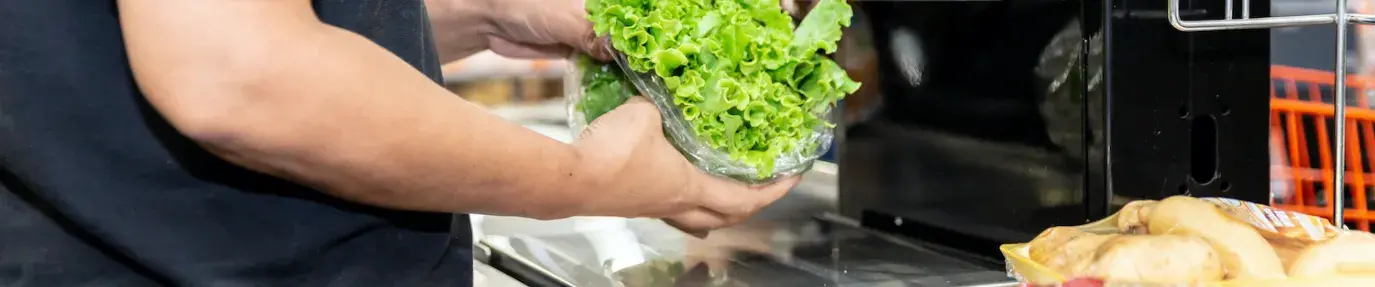 grocery store check out. produce packaged in plastic. reduce your waste foodprint with gardening.
