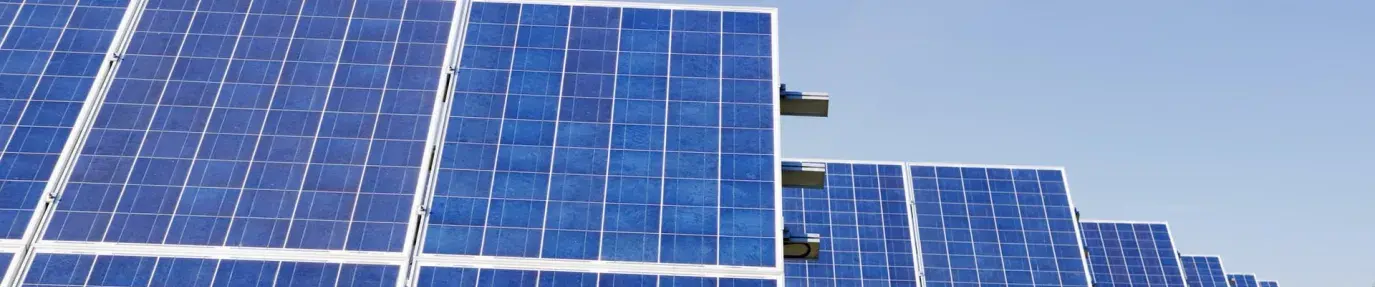 Image: solar panels in a field. Article: 5 Renewable Energy Myths Debunked